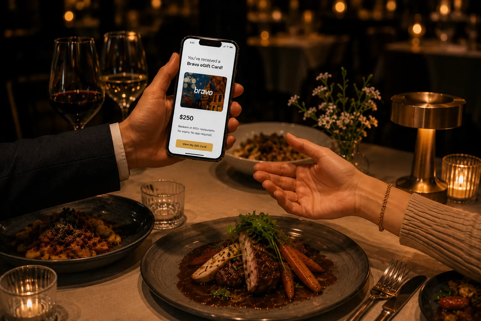 Hand holding a phone showing a Bravo eGift card in a restaurant